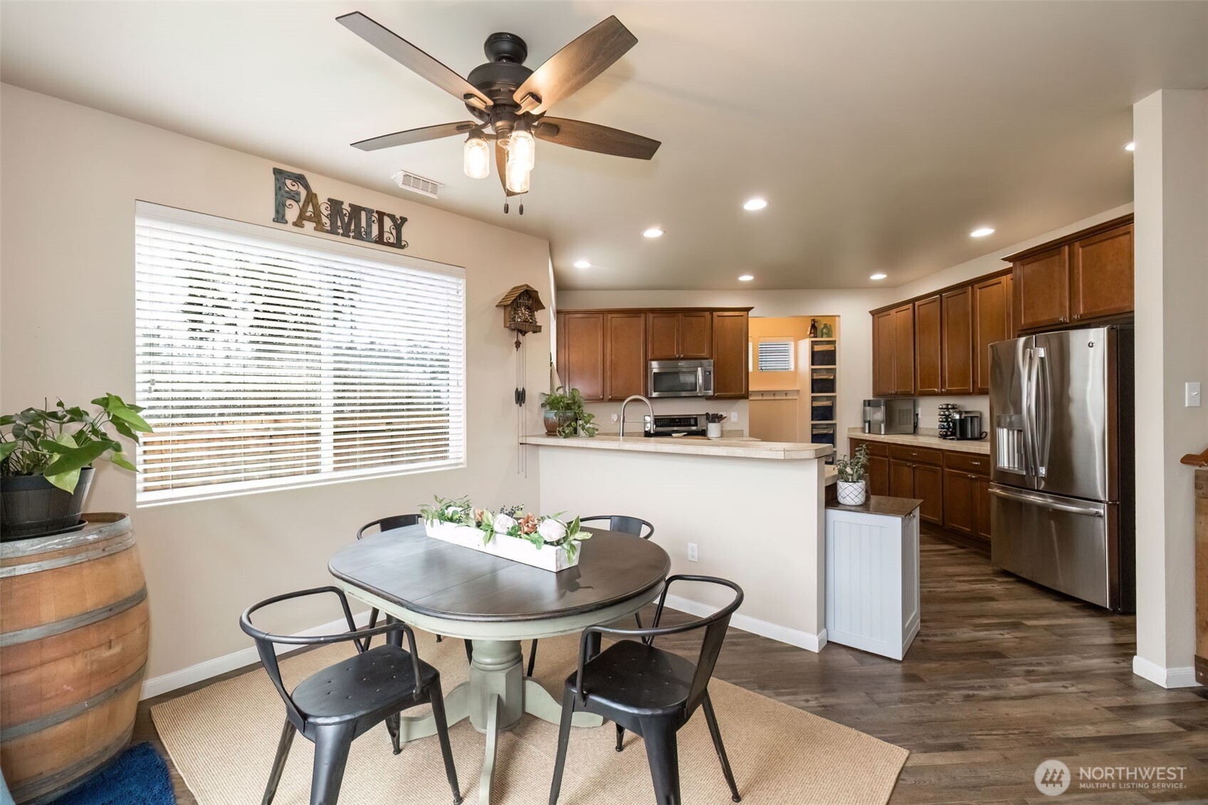 4189 Southwest Colbert Way Port Orchard, WA 98367 - Photo 15 of 38 a kitchen with stainless steel appliances kitchen island granite countertop a dining table chairs refrigerator and sink