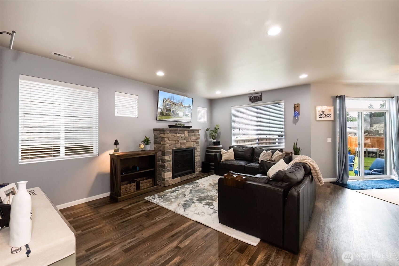 4189 Southwest Colbert Way Port Orchard, WA 98367 - Photo 6 of 38 a living room with fireplace furniture and a wooden floor
