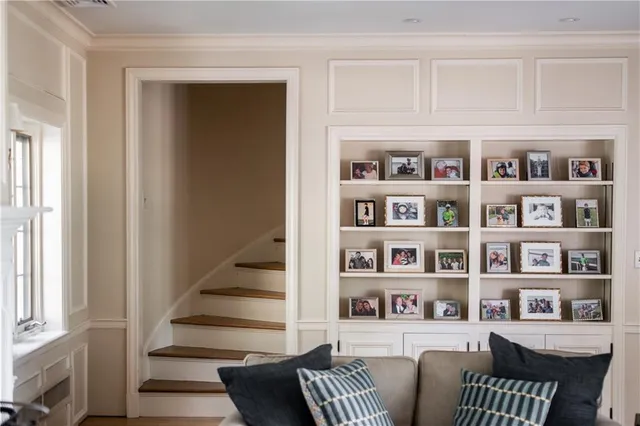 a living room with furniture and a book shelf