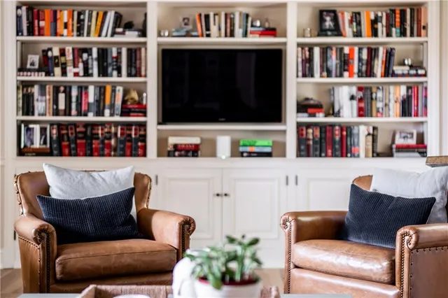 a living room with furniture and a book shelf