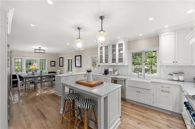 a kitchen with stainless steel appliances granite countertop a sink stove and wooden floor