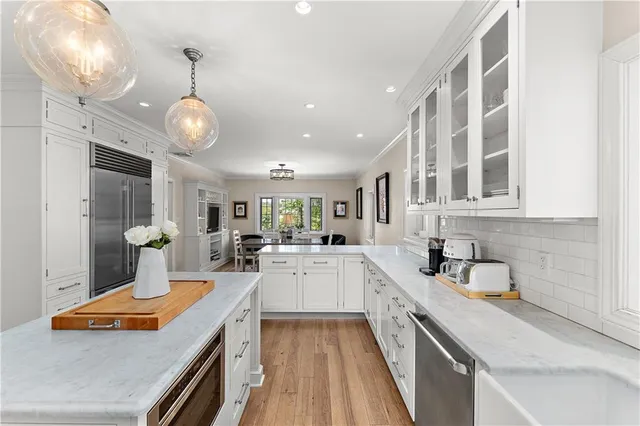 a kitchen with stainless steel appliances granite countertop a sink and cabinets