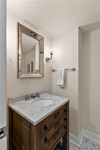 a bathroom with a sink vanity and a mirror