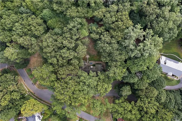 an aerial view of a house with a yard and outdoor seating