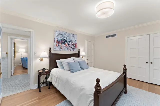 a bed room with a bed and a painting on the wall