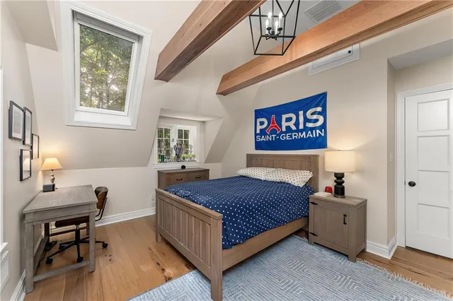 a bedroom with a bed and a table in it