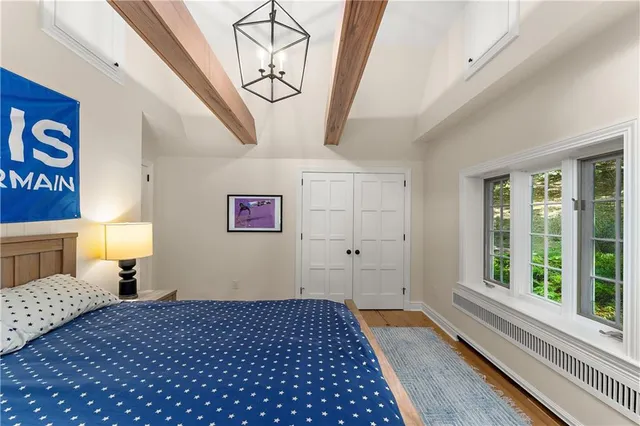 a bedroom with a bed and a window