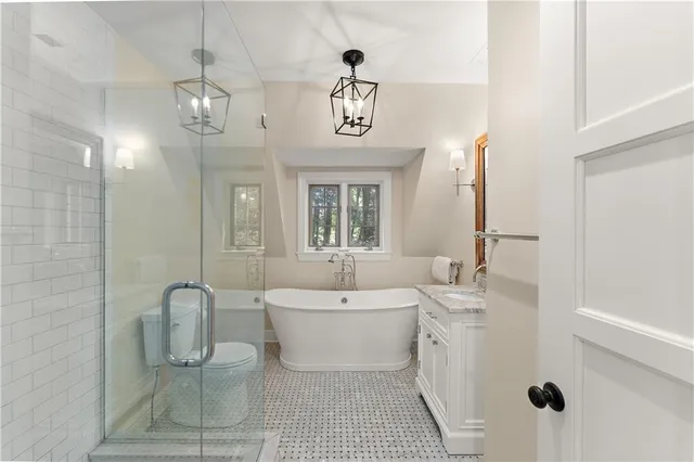 a bathroom with a double vanity sink a mirror and a bathtub