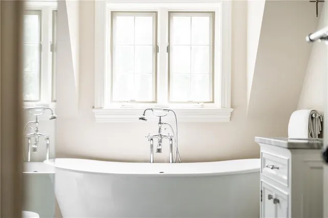 a white bath tub sitting next to a window