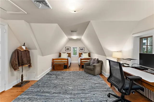 a bedroom with furniture and wooden floor