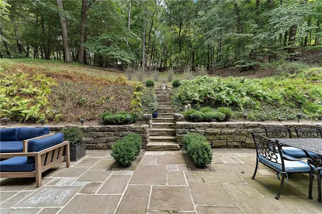 a view of patio with table and chairs and potted plants