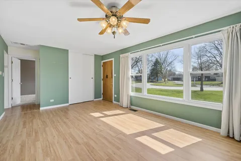 a view of a room with a large window with wooden floor