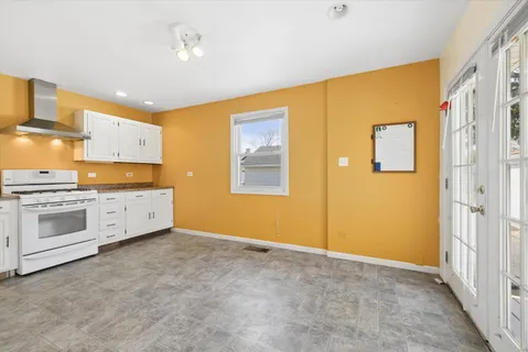 a view of a kitchen with microwave and stove top oven