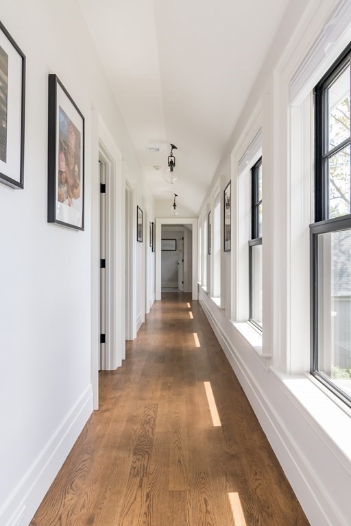 274 Manning Street Needham, MA 02492 - Photo 17 of 26 a view of a hallway with wooden floor and windows