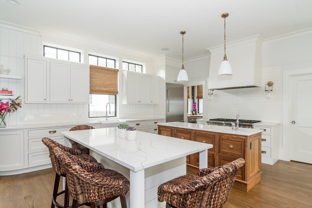 274 Manning Street Needham, MA 02492 - Photo 6 of 26 a kitchen with a stove a sink a dining table and chairs