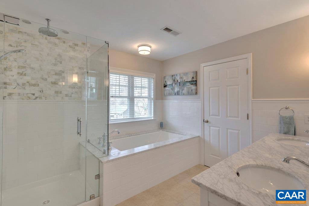 825 Village Road Charlottesville, VA 22903 - Photo 20 of 42 a bathroom with a tub sink and mirror