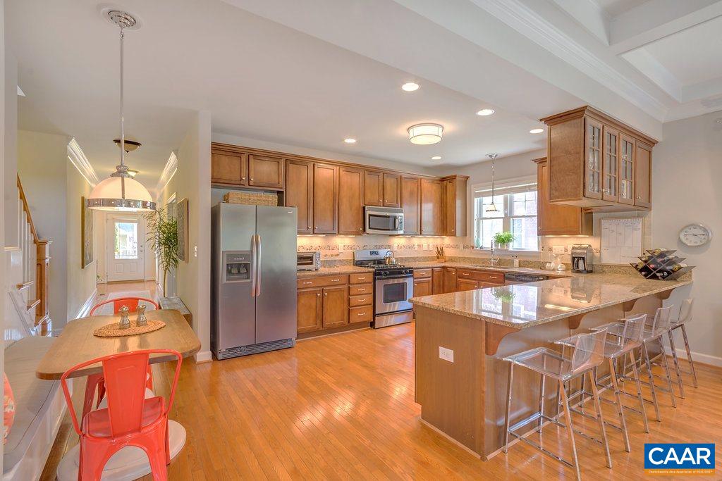 825 Village Road Charlottesville, VA 22903 - Photo 10 of 42 a kitchen with stainless steel appliances granite countertop a refrigerator a sink a stove and a wooden cabinets