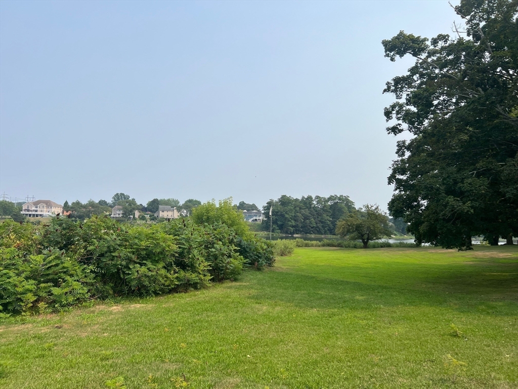 22 Eisenhower Road Swansea, MA 02777 - Photo 14 of 17 a view of a garden with a lake