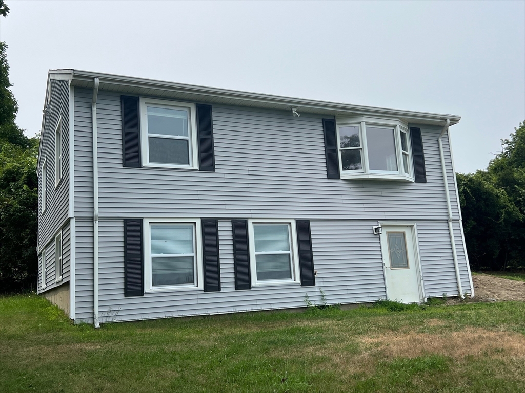 22 Eisenhower Road Swansea, MA 02777 - Photo 2 of 17 a front view of a house with a garden