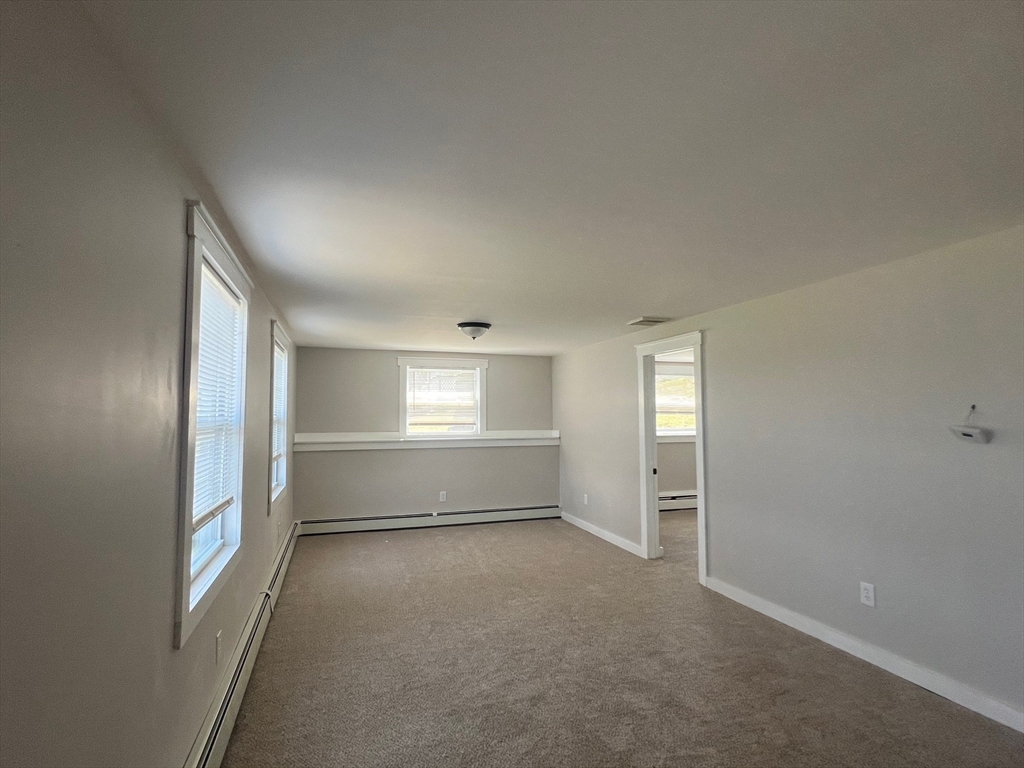 22 Eisenhower Road Swansea, MA 02777 - Photo 10 of 17 an empty room with windows and closet