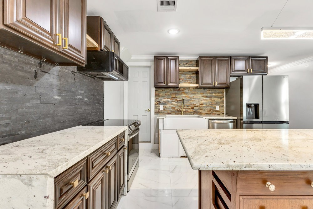 6325 Riverview Way, Unit ABCD Houston, TX 77057 - Photo 19 of 33 a kitchen with granite countertop a sink a stove and refrigerator