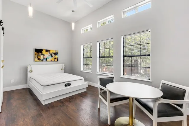 a living room with furniture a table and a large window