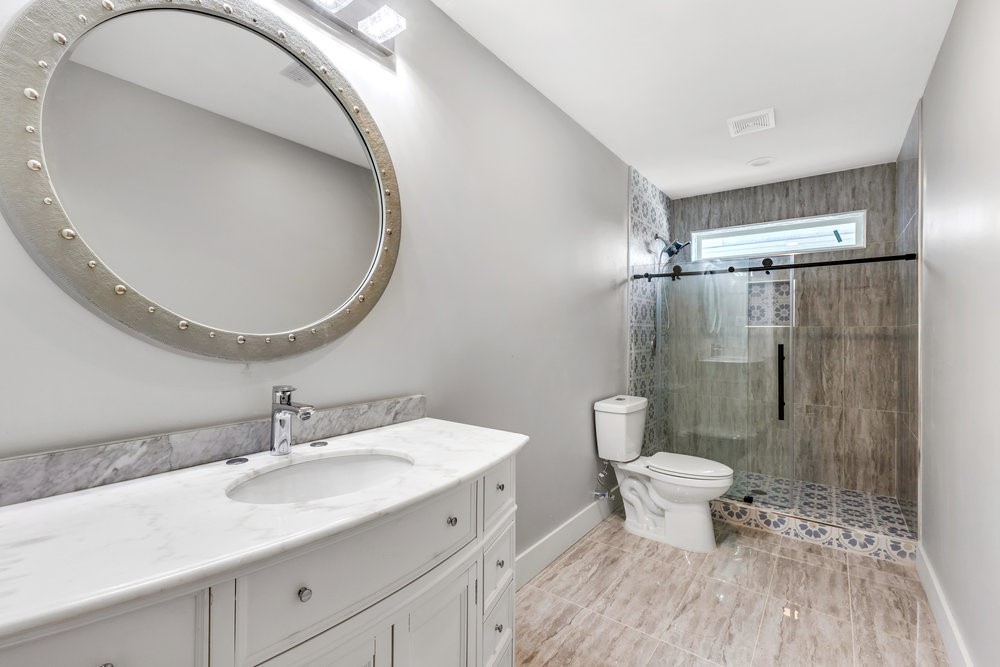 6325 Riverview Way, Unit ABCD Houston, TX 77057 - Photo 26 of 33 a bathroom with a sink toilet a mirror and shower