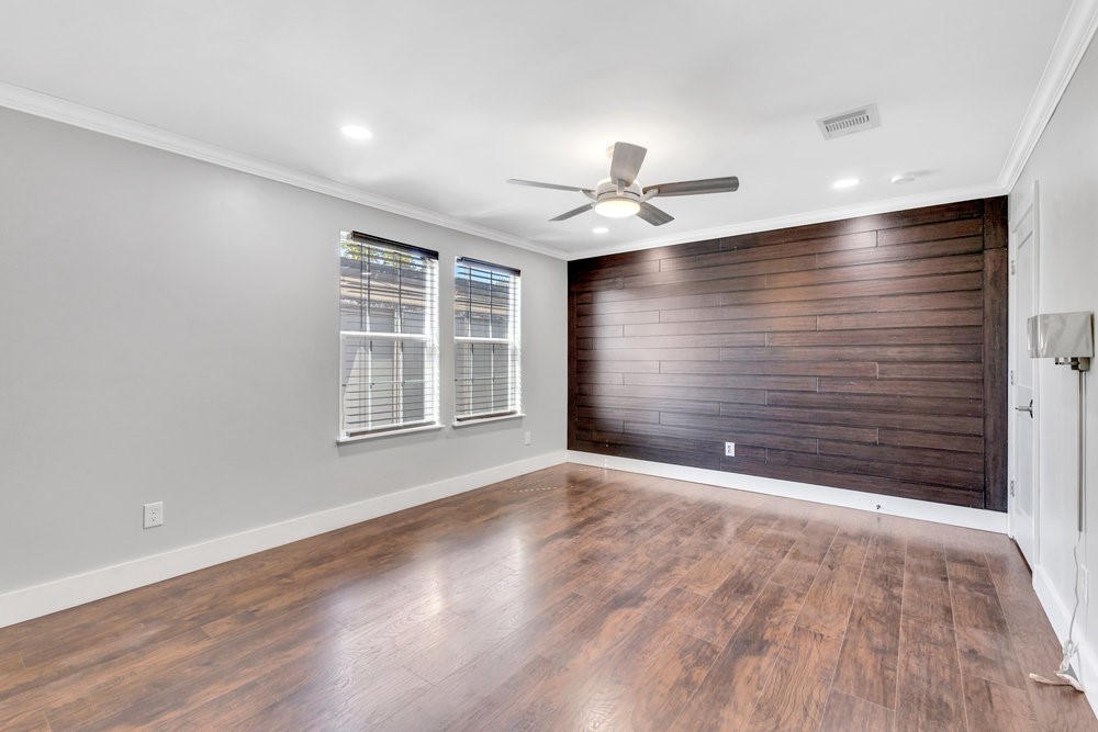 6325 Riverview Way, Unit ABCD Houston, TX 77057 - Photo 28 of 33 a view of an empty room with a window and wooden floor