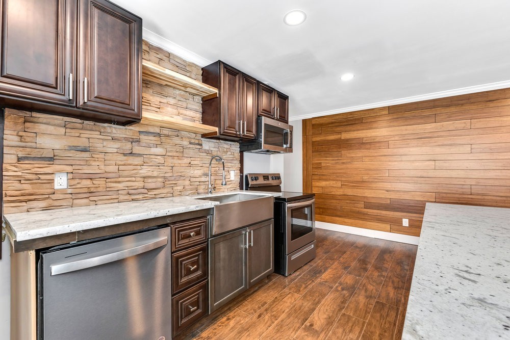 6325 Riverview Way, Unit ABCD Houston, TX 77057 - Photo 30 of 33 a kitchen with stainless steel appliances granite countertop a sink stove and oven