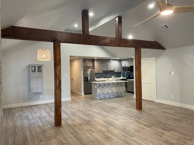 a view of a kitchen with a sink and refrigerator