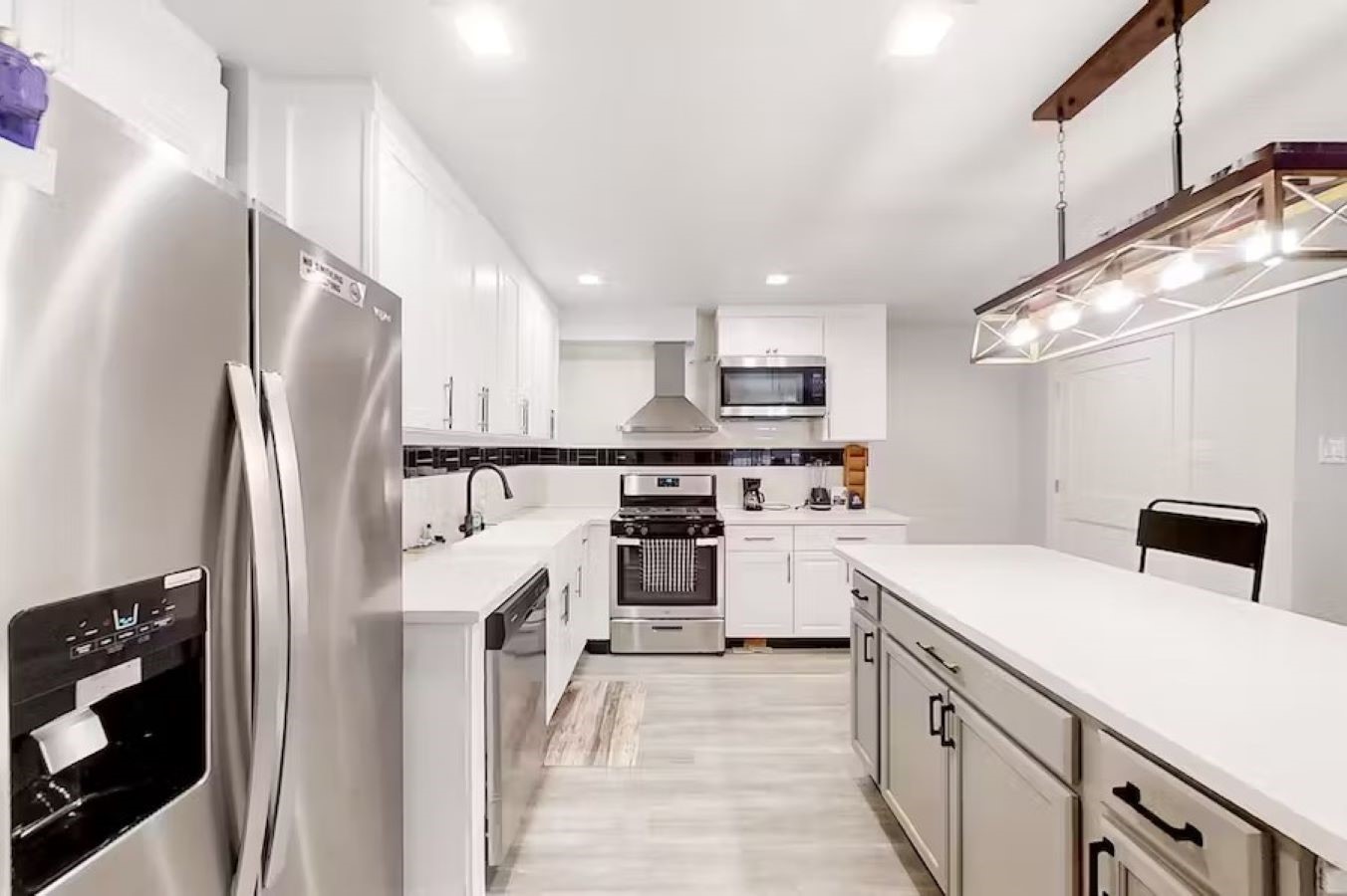 6325 Riverview Way, Unit ABCD Houston, TX 77057 - Photo 5 of 33 a kitchen with stainless steel appliances a refrigerator sink and cabinets