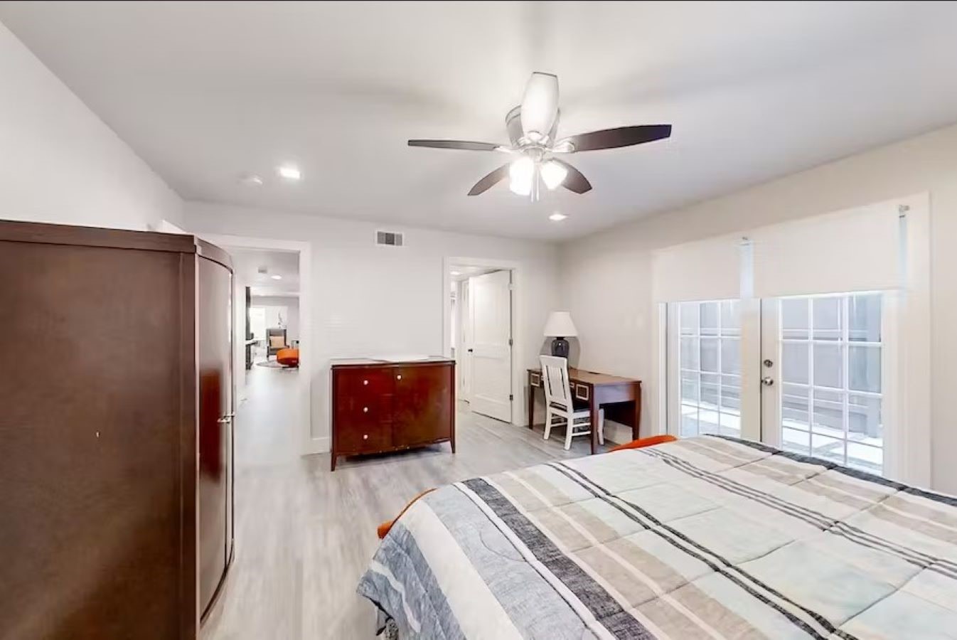 6325 Riverview Way, Unit ABCD Houston, TX 77057 - Photo 6 of 33 a bedroom with a bed and a chandelier