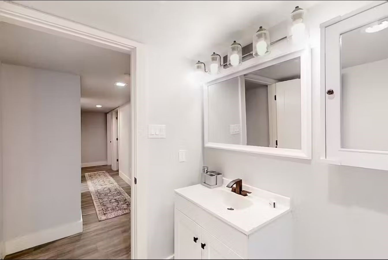 6325 Riverview Way, Unit ABCD Houston, TX 77057 - Photo 9 of 33 a bathroom with a sink mirror and vanity
