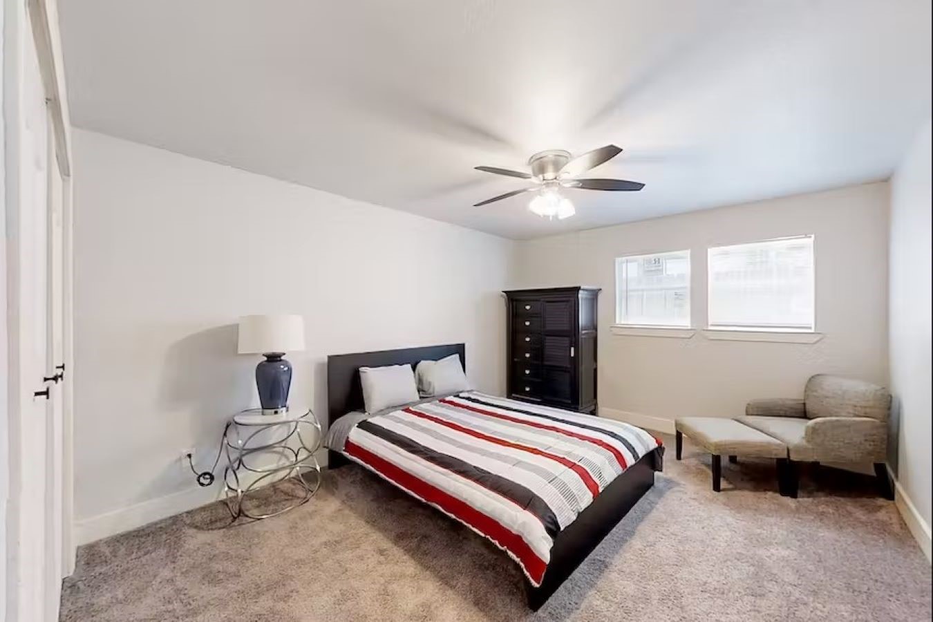 6325 Riverview Way, Unit ABCD Houston, TX 77057 - Photo 10 of 33 a bedroom with a bed and a chandelier