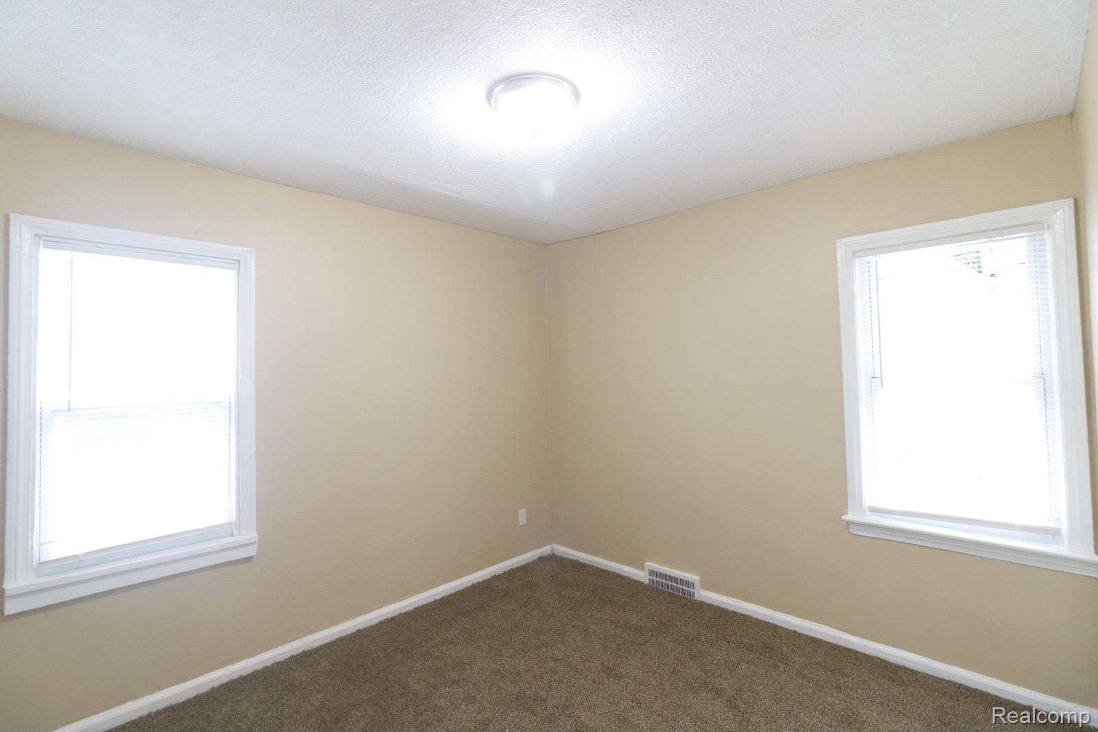 8096 Chamberlain Street Detroit, MI 48209 - Photo 4 of 10 Unfurnished room with baseboards and carpet floors