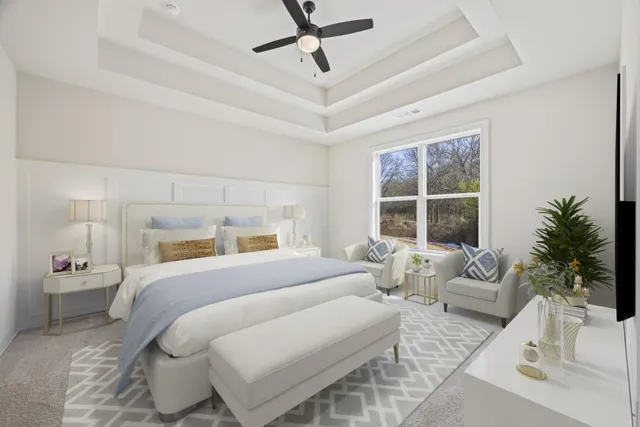 a spacious bedroom with a bed and ceiling fan