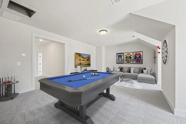 a bathroom with a granite countertop toilet sink and mirror