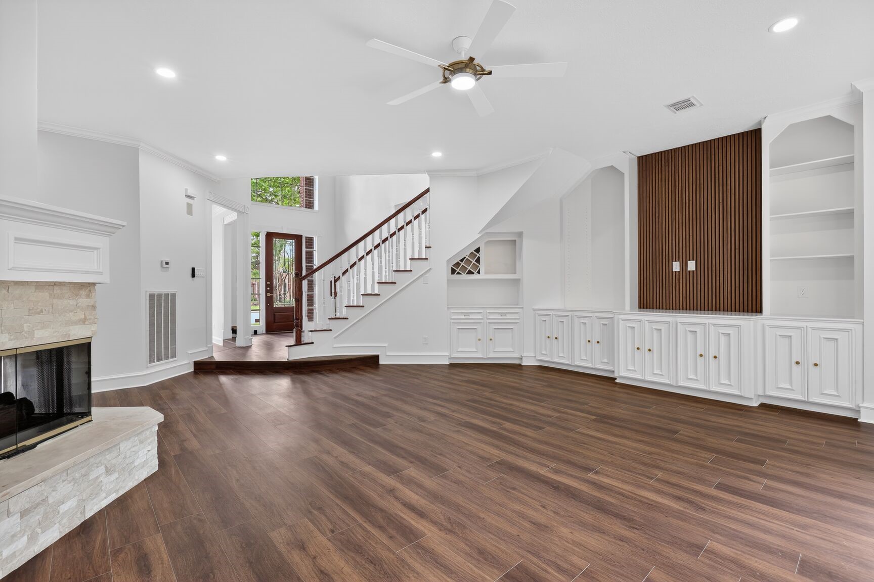 17519 Shelburne Lane Spring, TX 77379 - Photo 12 of 31 a view of an empty room with wooden floor fireplace and a window