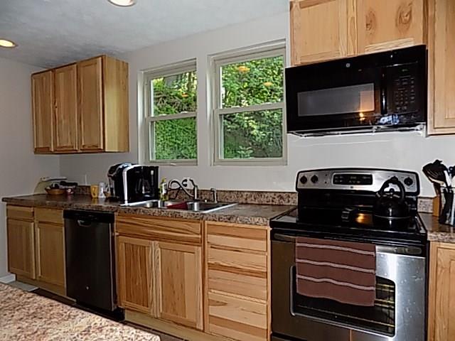 340 Thompson Run Road Pittsburgh, PA 15237 - Photo 4 of 23 This Modern Kitchen has maple cabinetry, lots of storage space, and breathtaking view overlooking the patio.