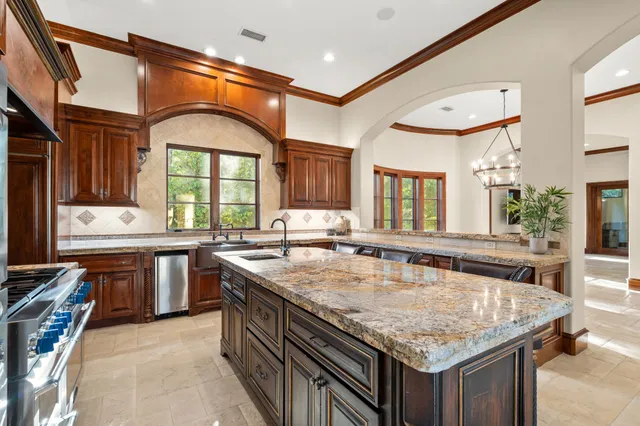 a kitchen with stainless steel appliances granite countertop a stove and a sink