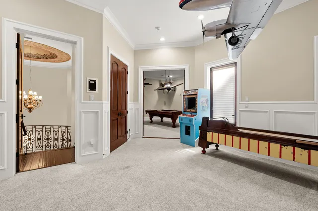 a view of a hallway with an empty room and staircase