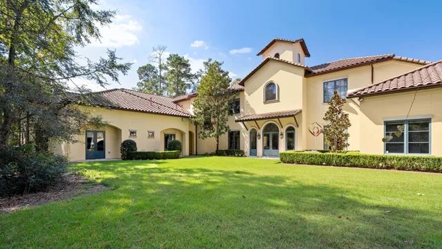 a view of a white house with a yard and garage