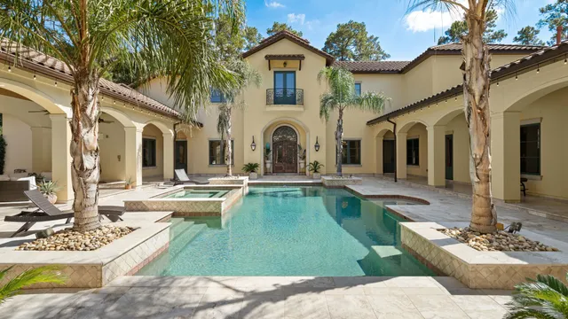 a view of a house with swimming pool and porch with furniture