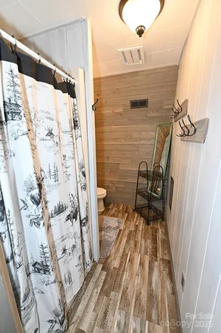 a view of a balcony with wooden floor and bench