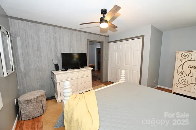 a bedroom with a bed and a flat screen tv