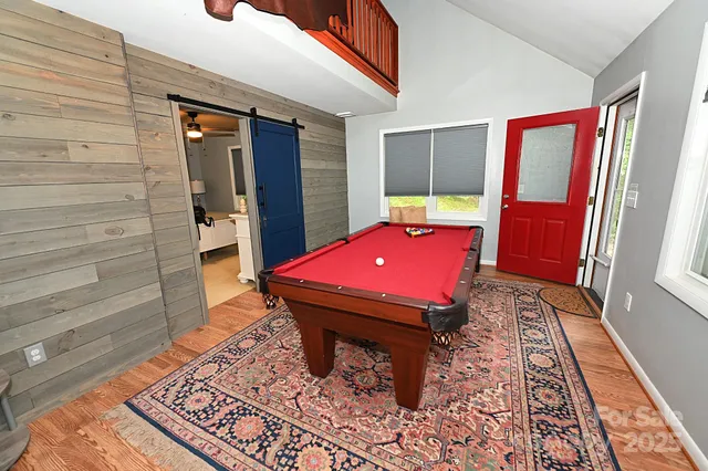 a room with pool table and windows
