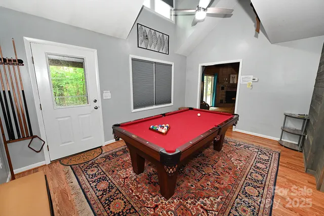a room with pool table and windows