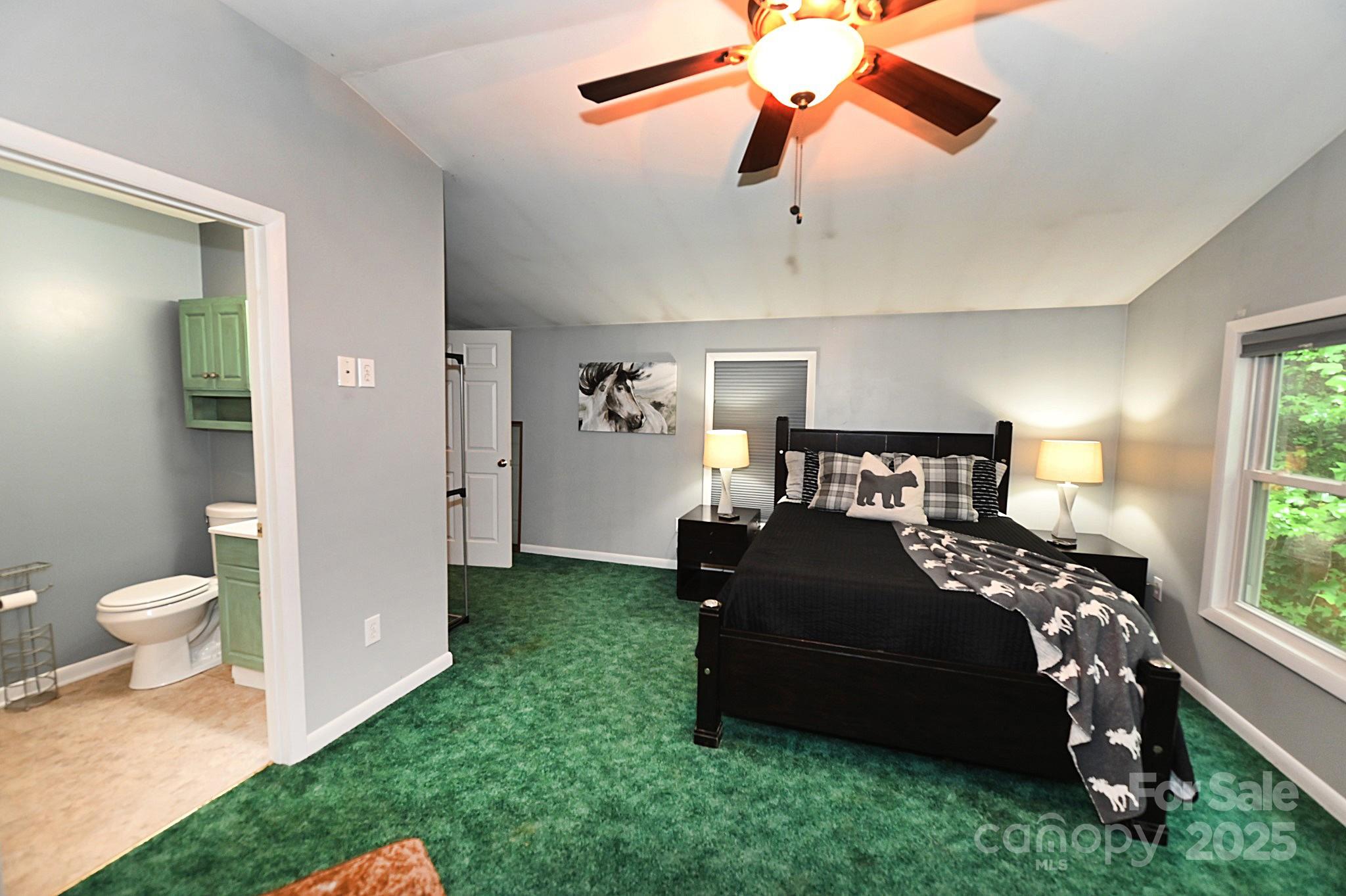 3430 Rose Creek Road Morganton, NC 28655 - Photo 21 of 48 a bedroom with a bed and a chandelier
