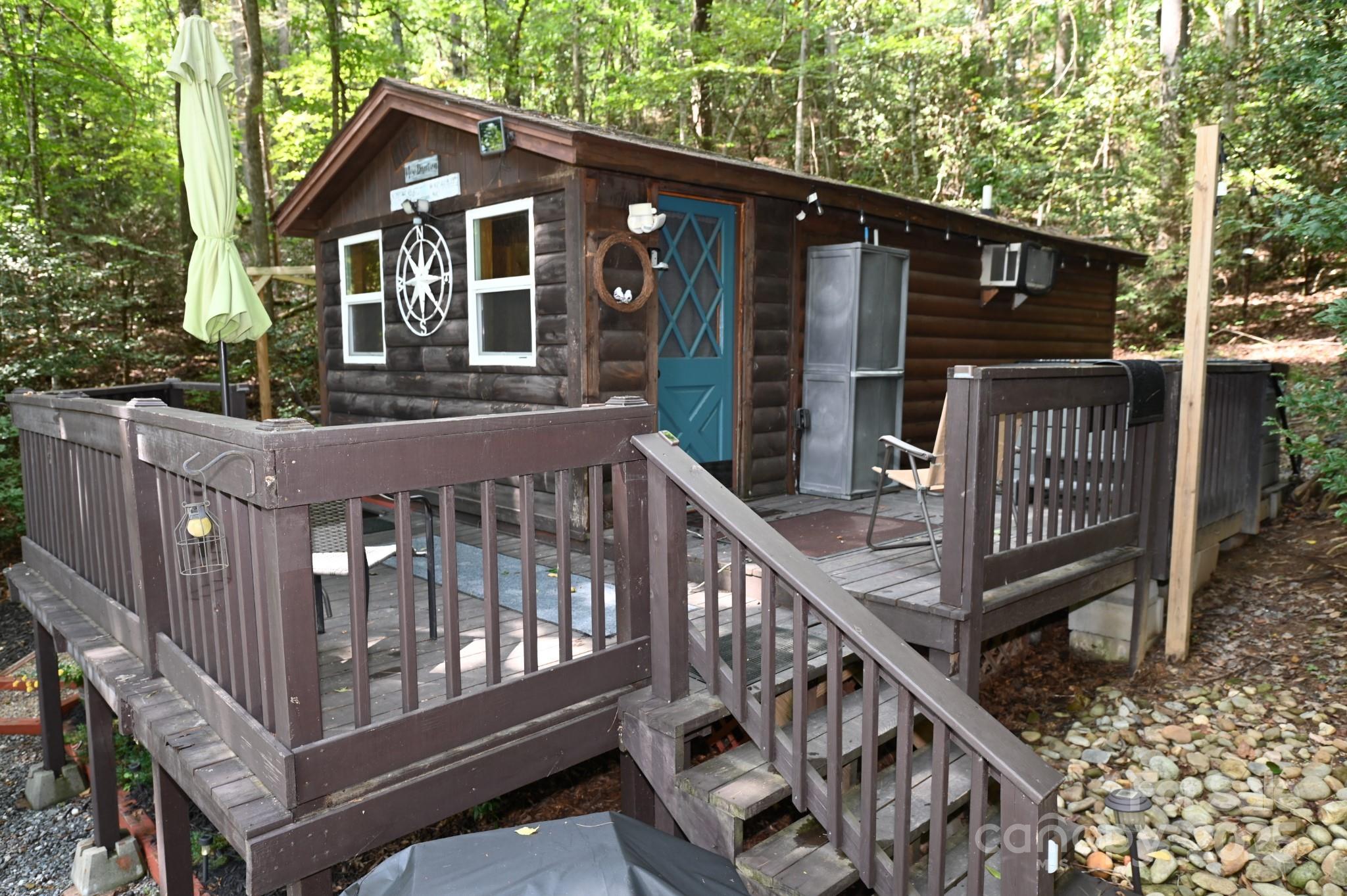 3430 Rose Creek Road Morganton, NC 28655 - Photo 24 of 48 a view of wooden house with a deck and a bench