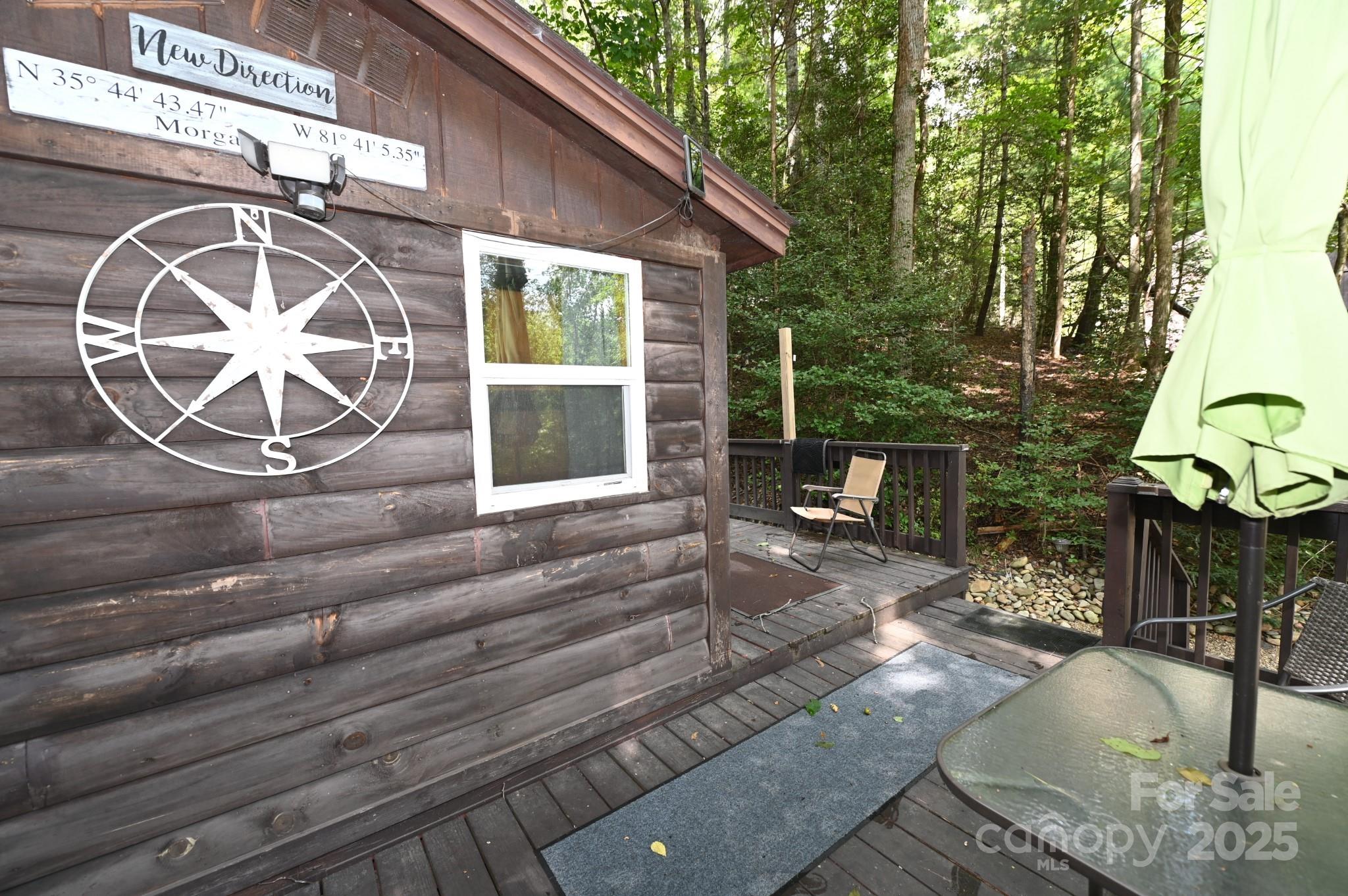 3430 Rose Creek Road Morganton, NC 28655 - Photo 25 of 48 a view of a patio with table and chairs with wooden floor and fence